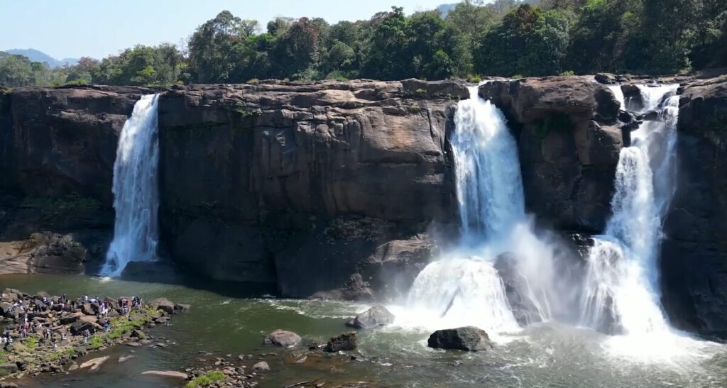Athirappilly Waterfalls flowing through green forest in Kerala