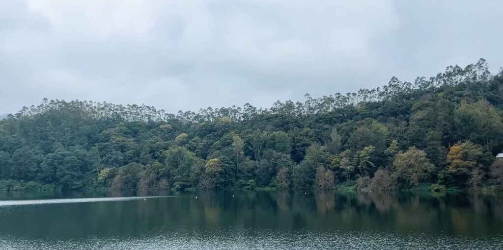 Scenic view of Kundala Dam with mountains and cloudy sky in Munnar - Kundala Dam