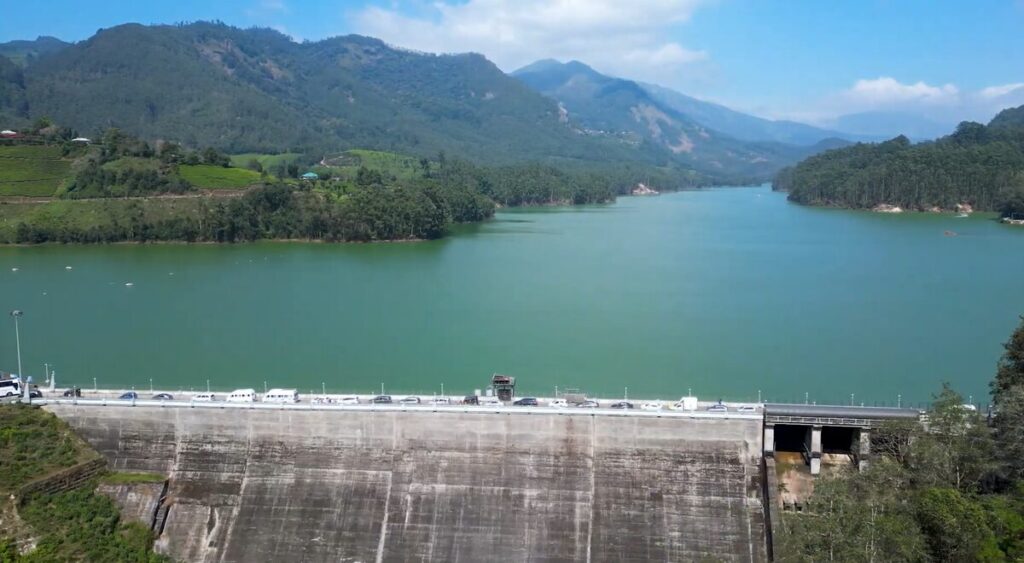 Calm waters of Mattupetty Dam surrounded by green hills near Munnar