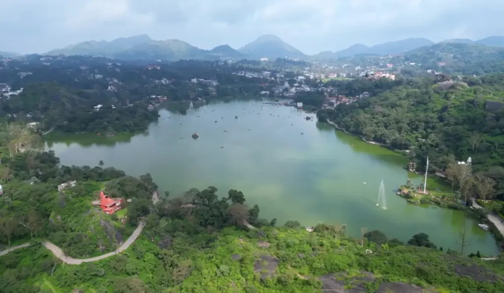 Panoramic view of Nakki Lake with hills and town in the background